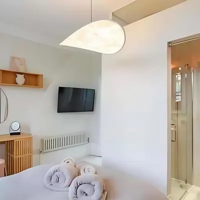 a bedroom with a bed with towels on it at Elegant, Victorian End of Terrace Town House in Southend-on-Sea