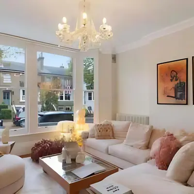 a living room with a white couch and a chandelier at Elegant, Victorian End of Terrace Town House in Southend-on-Sea