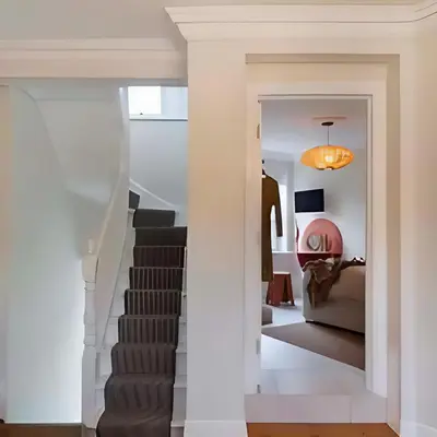 a hallway with a stairway leading to a living room at Elegant, Victorian End of Terrace Town House in Southend-on-Sea