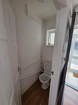a bathroom with a toilet and a window at Spacious Double Room in Basildon Essex in Basildon