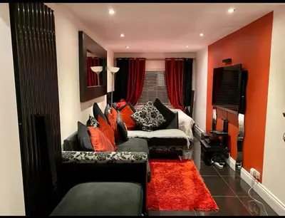 a living room with a couch and a window at Amazing studio room in a beautiful house in Stanford le Hope