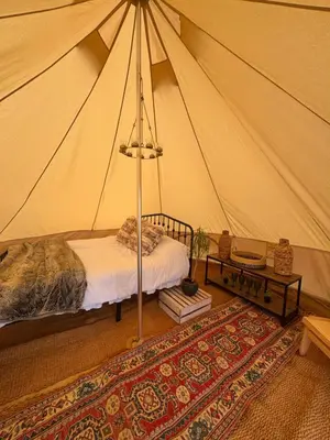 a bedroom with a bed in a tent at Farmview Bell Tent in Messing