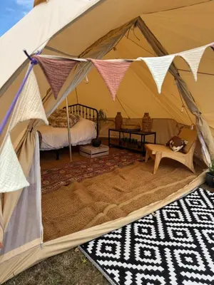 a tent with a bed and a table in it at Farmview Bell Tent in Messing