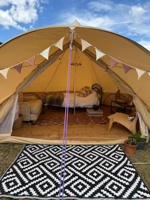 a large tent with a bed and a rug at Farmview Bell Tent in Messing