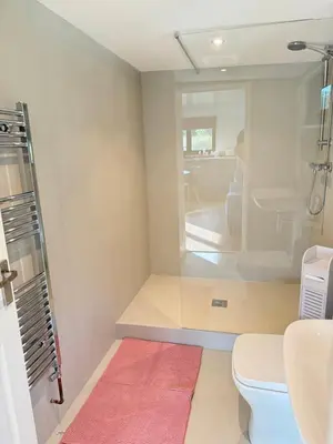 a bathroom with a toilet and a sink at The Den in Scoulton