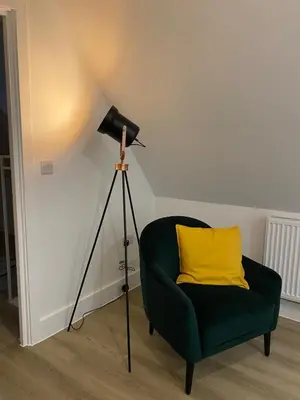 a lamp and a green chair with a yellow pillow at Modern Stay - Walk to Everything 6 in Ipswich
