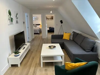 a living room with a couch and a tv at Modern Stay - Walk to Everything 6 in Ipswich