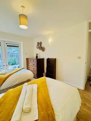 a bedroom with two beds and a window at Spacious 2 Bedroom Sleeps 4 with WiFi & Garden in Cambridge