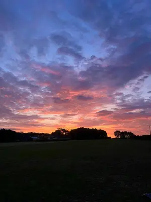 a sunset in a field with a sky at The Old Stable in Messing