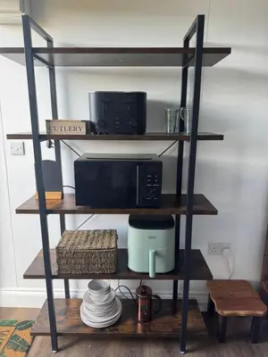 a shelf with a microwave and a coffee maker on it at The Old Stable in Messing