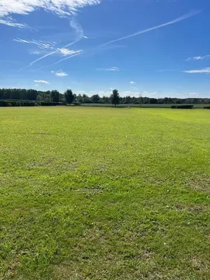 a large field of green grass with a blue sky at The Old Stable in Messing