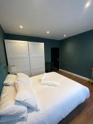 a large white bed with two pillows on it at Two double bedroom self contained Retreat in Thundersley