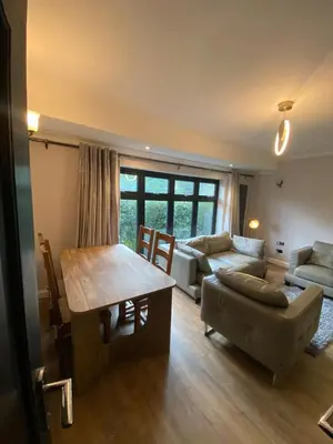 a living room with a couch and a table at Two double bedroom self contained Retreat in Thundersley