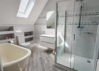 a bathroom with a shower and a sink and a toilet at Oceanfront 4BR Beach Retreat in Holland-on-Sea