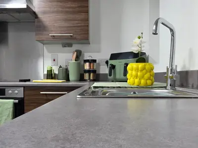 a kitchen counter with a sink with lemons on it at Entire 3-Bed Home, 5 mins to City Centre, Sleeps 6, 2 Free Parking in Colchester
