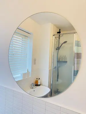 a bathroom mirror with a shower and a sink at Entire 3-Bed Home, 5 mins to City Centre, Sleeps 6, 2 Free Parking in Colchester