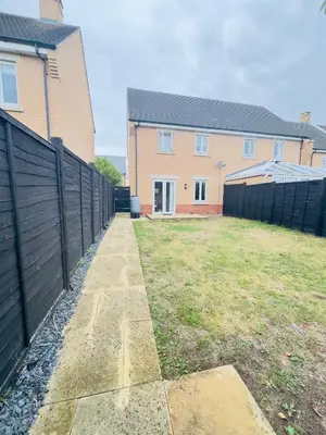 a backyard with a fence and a house at Entire 3-Bed Home, 5 mins to City Centre, Sleeps 6, 2 Free Parking in Colchester
