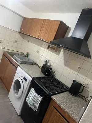 a kitchen with a stove and a washing machine at Clayburn Spacious Twin Bed Large Room in Basildon