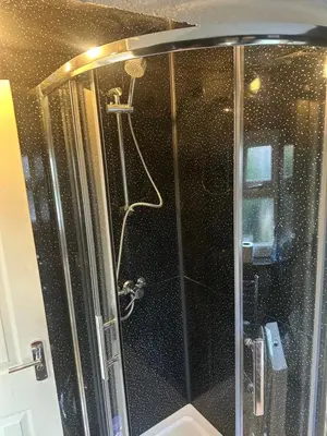 a shower in a bathroom with a toilet at Clayburn Spacious Twin Bed Large Room in Basildon