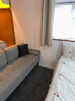 a living room with a couch and a window at Clayburn Spacious Twin Bed Large Room in Basildon