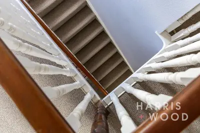 a set of stairs with white railings and a stair case at Beaulieu in East Bergholt