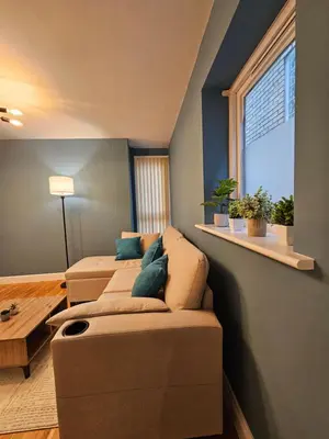 a living room with two couches and a window at Gorgeous Flat with Charming Patio in Cambridge