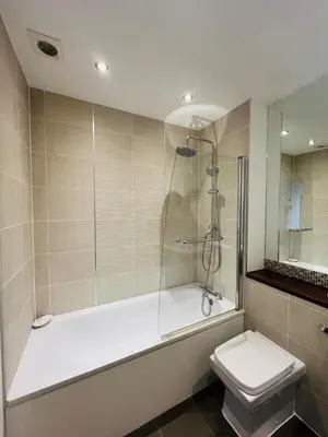 a bathroom with a shower and a toilet at 503 Focus Apartments in Ipswich