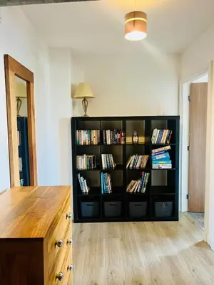 a book shelf filled with books in a room at 503 Focus Apartments in Ipswich