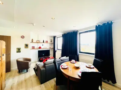 a living room with a table and a couch at 503 Focus Apartments in Ipswich