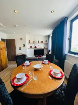 a table in a living room with a table and chairs at 503 Focus Apartments in Ipswich