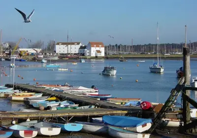 a bunch of boats are docked in a harbor at Lime Kiln Quay Cottage in Woodbridge