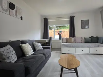 a living room with a couch and a table at Grace's Place in Littleport in Littleport