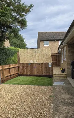 a wooden fence in a yard next to a house at Grace's Place in Littleport in Littleport