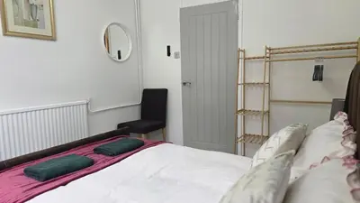 a bedroom with a bed and a chair in it at Grace's Place in Littleport in Littleport