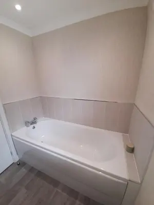 a white bath tub in a bathroom with a floor at Pullman Lodge in Glemsford