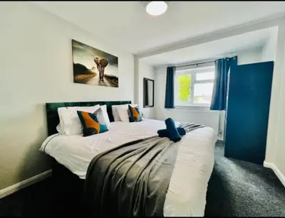 a bedroom with two beds and a window at Spacious 6 Bedroom House Basildon with Free Parking for Contractors and Business - Free Parking l sleeps 12 in Basildon