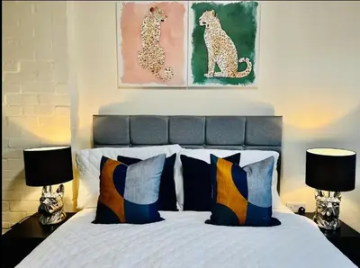 a bedroom with a bed with two lamps on tables at Spacious 6 Bedroom House Basildon with Free Parking for Contractors and Business - Free Parking l sleeps 12 in Basildon
