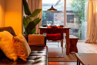 a living room with a couch and a table at Modern and Stylish Townhouse in City Centre Pass the Keys in Cambridge