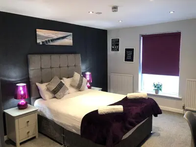 a bedroom with a large bed and a window at OYO Watton Vibe Hotel in Watton