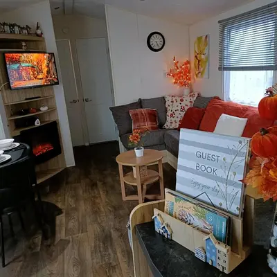 a living room with a couch and a table at Centrix at Seawick Holiday Park in Saint Osyth