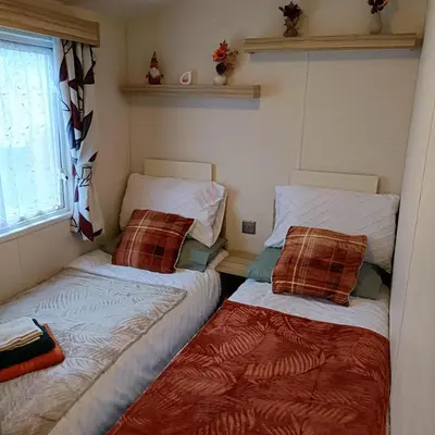 two beds sitting next to each other in a room at Centrix at Seawick Holiday Park in Saint Osyth