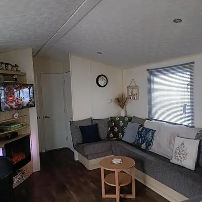 a living room with a couch and a table at Centrix at Seawick Holiday Park in Saint Osyth