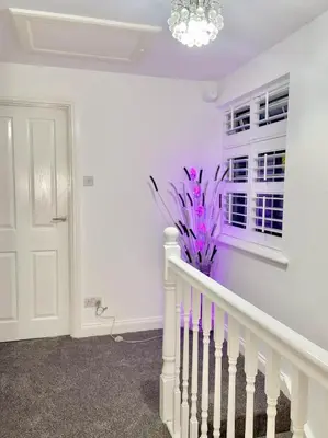 a white staircase with purple walls and a window at Relaxed Leigh-on-Sea Escape, Family-Friendly & Contractor Stays in Hockley