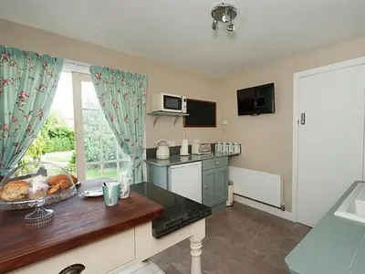 a kitchen with a table and a counter top at The Porterhouse Pub & Restaurant Cambridge in Willingham