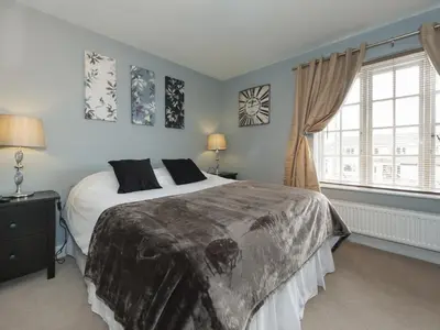 a bedroom with a large bed and a window at The Porterhouse Pub & Restaurant Cambridge in Willingham