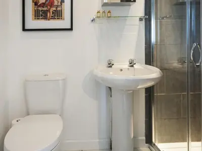 a bathroom with a toilet and a sink and a shower at The Porterhouse Pub & Restaurant Cambridge in Willingham