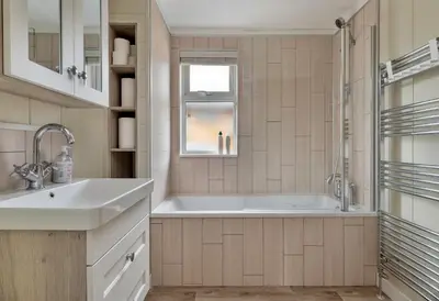 a bathroom with a tub and a sink and a window at Finest Retreats - Cambridge Luxury Lodge