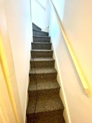 a stairway in a building with a stair case at Historical Building - Cozy Basement Apartment- Central Location in Cambridge