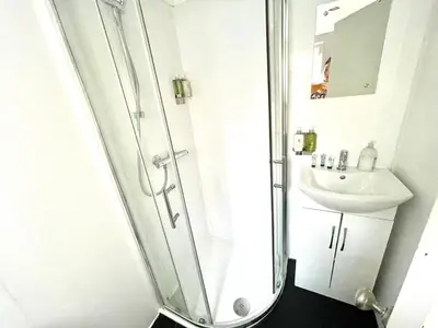 a bathroom with a shower and a sink at Historical Building - Cozy Basement Apartment- Central Location in Cambridge