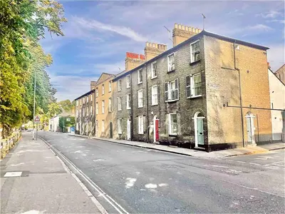 an empty city street with buildings on the side at Historical Building - Cozy Basement Apartment- Central Location in Cambridge